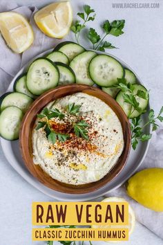 raw vegan classic zucchini hummus served with sliced cucumbers and parsley