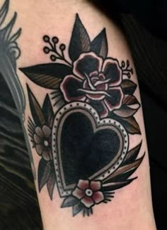 a tattoo with a heart and flowers on it