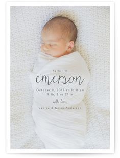 a baby wrapped in a blanket with the word, emerson on it