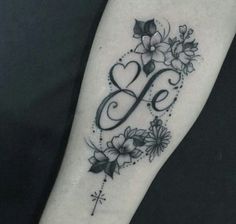 a black and white photo of a tattoo with flowers on the arm that says i love you