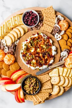 a platter filled with crackers, cheese and fruit