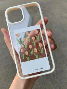 a person holding up a phone case with flowers on it