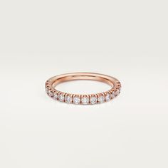 a rose gold wedding band with five round diamonds on the top and bottom, set in 18k rose gold