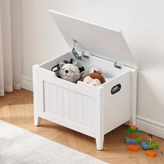 a white toy chest with stuffed animals in it