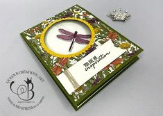 a close up of a card with a dragonfly on it