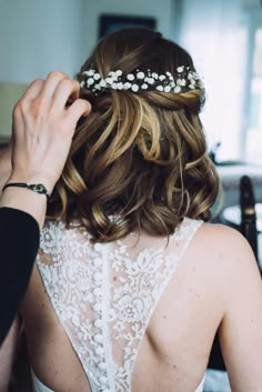 the back of a woman's head wearing a wedding dress