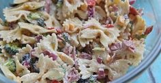 a bowl filled with pasta salad on top of a blue table