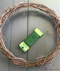 a wreath made out of branches with a tube of toothpaste in the middle