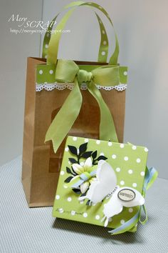 two small bags with bows on them sitting next to each other, one is green and the other has white polka dots