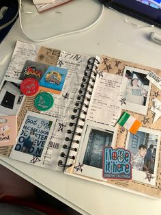 an open notebook with pictures and stickers on it