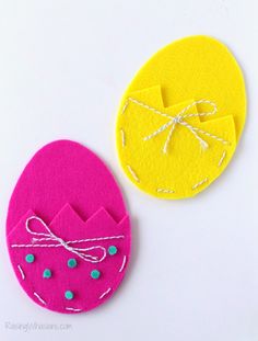 two felt easter eggs with bows on them