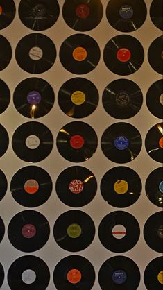 many different colored and black records are on display