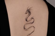 a woman's shoulder with a tattoo on the back of her neck and a snake