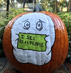 a pumpkin that has been painted with the words i see real people on it