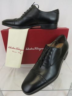 SALVATORE FERRAGAMO BOSTON BLACK BROGUE LEATHER GANCINI BIT LACE-UP OXFORDS By SALVATORE FERRAGAMO MADE IN ITALY 100% AUTHENTIC,GUARANTEED !!!!! Size: US 10 D Color: Black (Print on the box) Calf leather upper Leather Lace-Up Detail Leather lined "SALVATORE FERRAGAMO" stamped leather insole "Ferragamo" Lettering Stamped logo Rubber sole Silver tone metal Gancini bit detail at the back Heel Brogue Almond Cap Toe Original Price: $695 NOTE !!! These shoes came from Ferragamo's brand name store in i Designer Fitted Leather Office Shoes, Designer Black Cap Toe Oxfords, Designer Fitted Oxfords With Pointed Toe, Designer Brogue Oxfords For Business, Designer Oxfords With Brogue Detailing For Business, Designer Fitted Leather Shoes With Cap Toe, Designer Fitted Cap Toe Leather Shoes, Designer Fitted Leather Business Shoes, Designer Brogue Leather Shoes For Business Casual