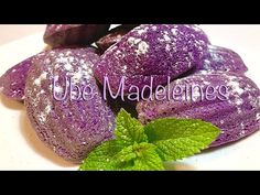 purple powdered pastries with green leaves on top and the words ube madeanence above them