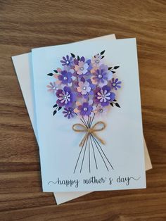 a mother's day card with purple flowers and a bow on the front that says, happy mother's day