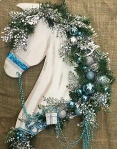 a white horse decorated with blue and silver ornaments