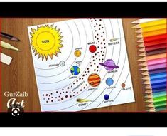 the solar system coloring book with colored pencils and crayons on a table