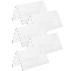 four clear acrylic signs on white background