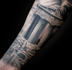 a man's arm is covered in black and grey ink with an image of the lincoln memorial