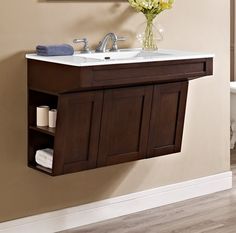 a bathroom with a sink, mirror and towel rack on the wall next to a toilet