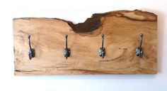 a piece of wood that has some hooks on it and is attached to the wall