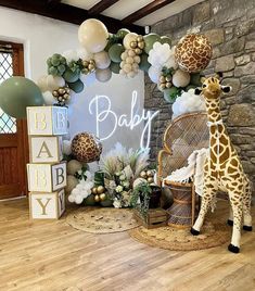 a baby shower with giraffes, balloons and other decorations on the wall