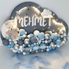 a sign that says mehmet with some lights on it and a teddy bear in the clouds