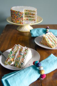 two plates with slices of cake on them and one slice has sprinkles