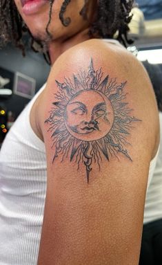 a woman with a sun and moon tattoo on her arm