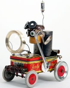 an old fashioned toy fire engine with tools on it's back wheel and wheels