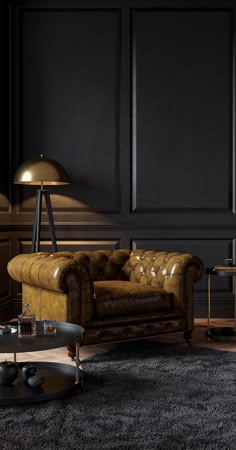 an elegant living room with black walls and leather couches, coffee table and lamp