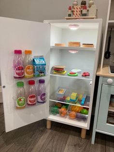 an open refrigerator filled with lots of different types of juices and condiments