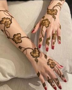 a woman's hands with hennap and flowers on them