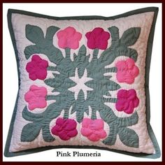 a pink and green flowered pillow on a white background with the words, this is an applique