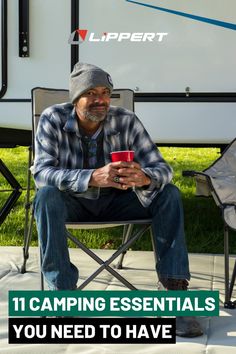 a man sitting in a chair next to a camper with the words camping essentials you need to have