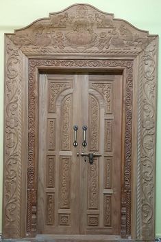 a wooden door with ornate carvings on it