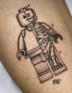 a tattoo with a lego figure on it