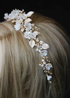 a woman with blonde hair wearing a white flower headpiece