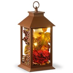 a lantern that is filled with flowers and berries