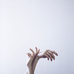 two hands reaching up into the air