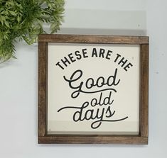 there are the good old days sign on the wall next to a potted plant