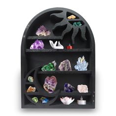 a black shelf with various rocks and crystals on it's sides, in the shape of an arch