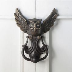 an owl shaped door handle on a white door