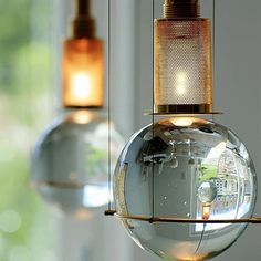 two glass balls hanging from the ceiling next to each other