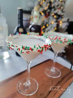 two martinis sitting on top of a wooden table