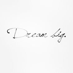 the word dream is written in cursive ink on a white paper with black writing