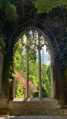 an old building with ivy growing on it's walls and large arched windows in the middle