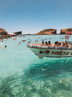 people are swimming in the ocean on a boat